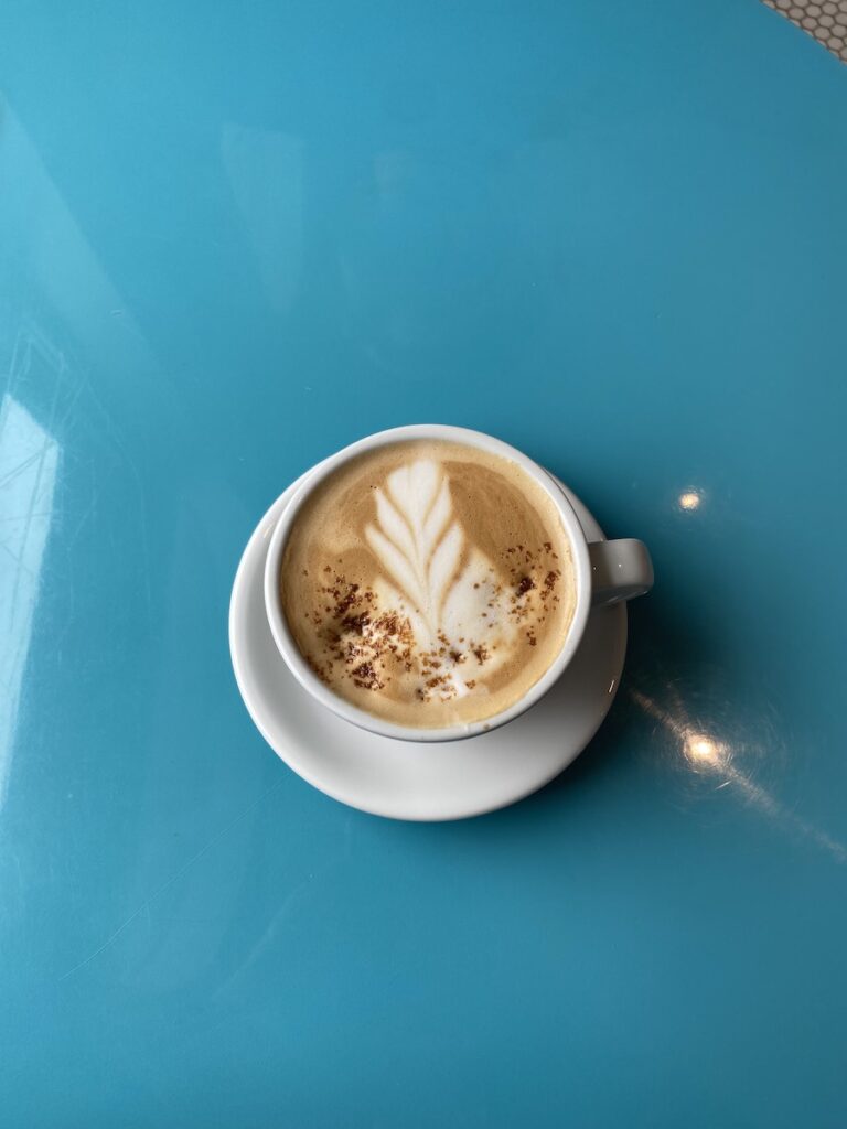 cinnamon latte on a bright blue table